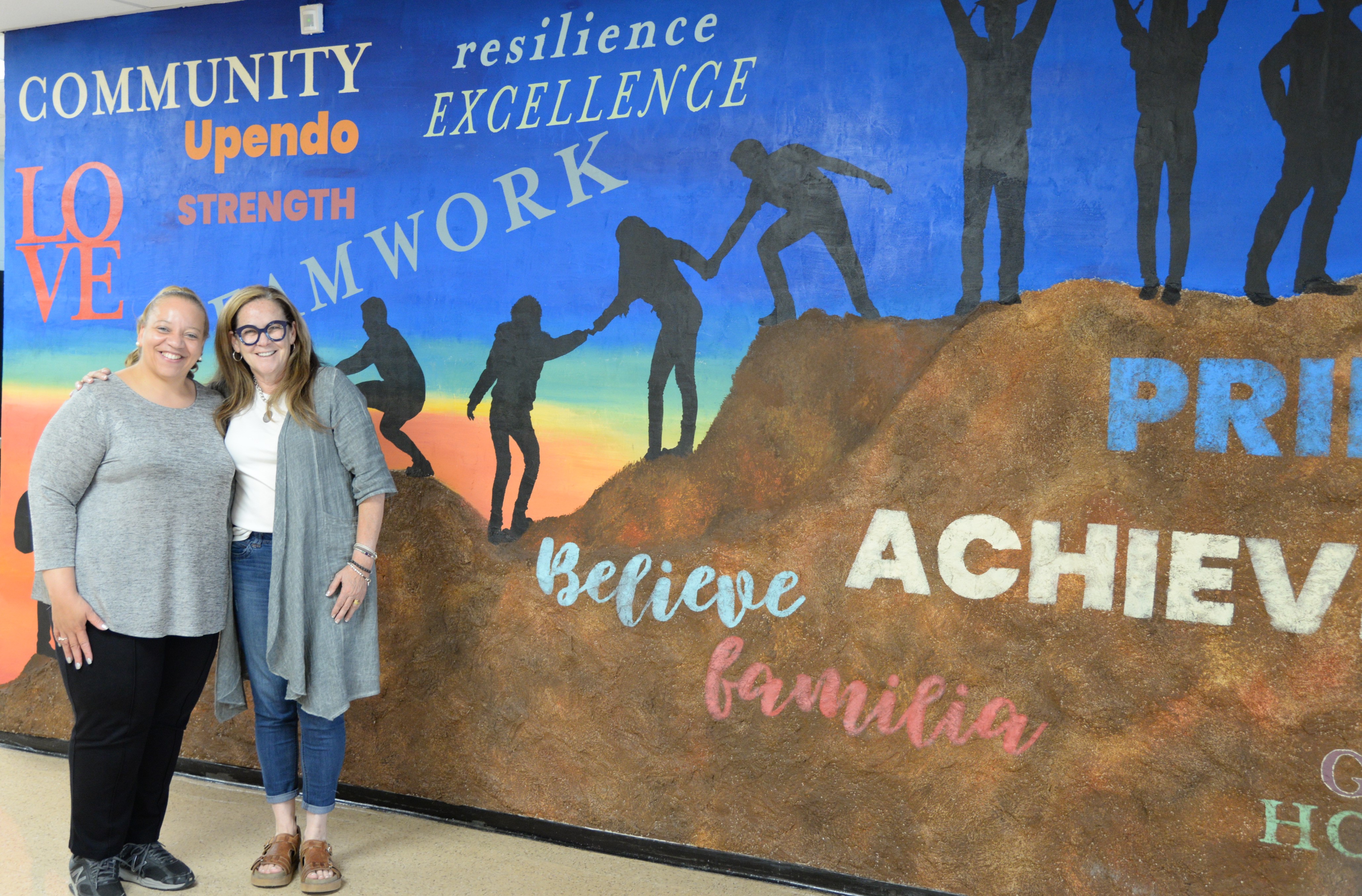 Austin-East Magnet High School principal Tammi Campbell and artist Eugenia Almeida highlight a new mural in the school's front lobby.